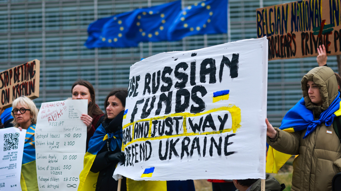 Украинци на протест с искане за използването на замразените руски активи, по време на срещата на Съвета по икономически и финансови въпроси (Екофин) в Брюксел, 12 декември 2025 г.